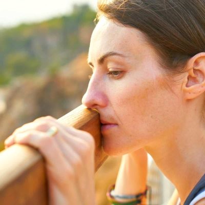 a woman leaning on a railing